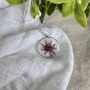 Silver Round Necklace With A Purple Flower