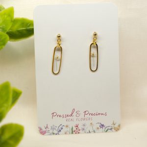 Gold Slim Oval Earrings With a White Flower