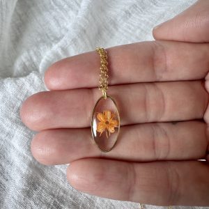Gold Oval Necklace With A Single Orange Flower