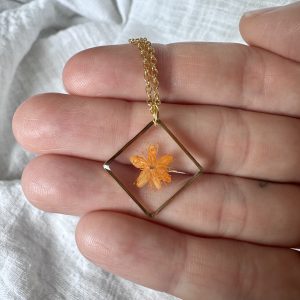 Gold Square Necklace With An Orange Flower
