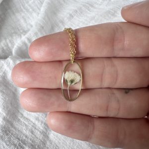 Gold Oval Necklace With A Single White Flower