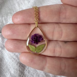 Large Gold Teardrop Necklace With A Purple Flower And Leaves